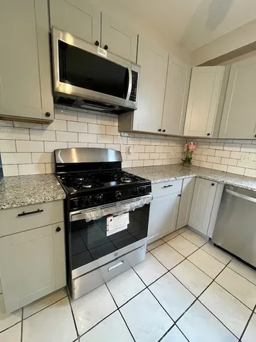 a kitchen with a stove and a microwave