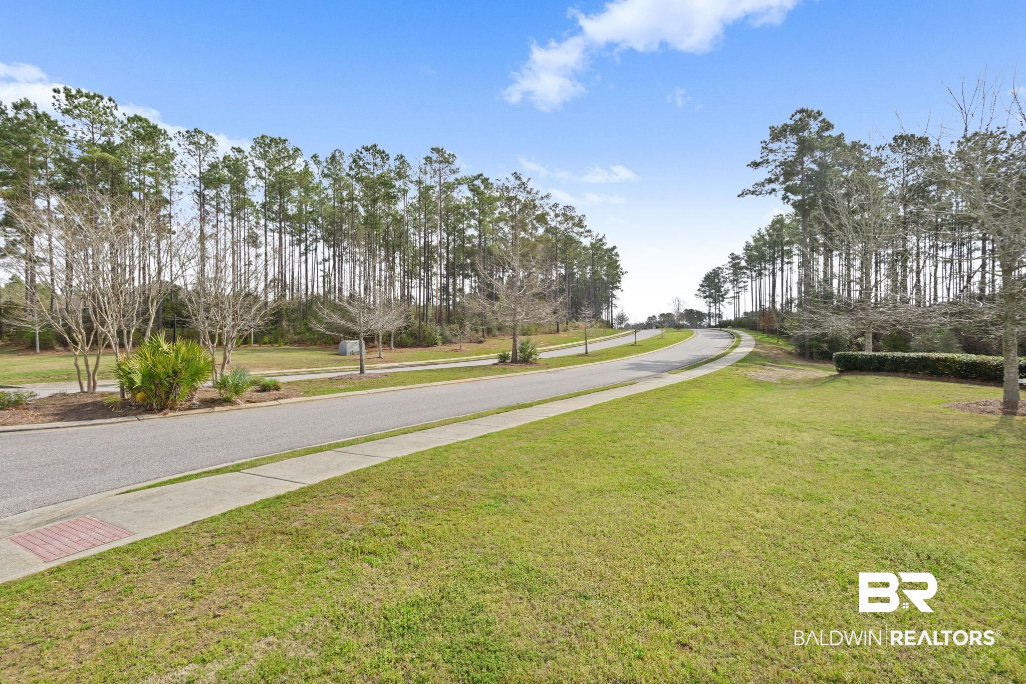 12693 Waxwing Avenue Daphne, AL 36527 - Photo 36 of 43 View of asphalt street with sidewalks and view of wooded area