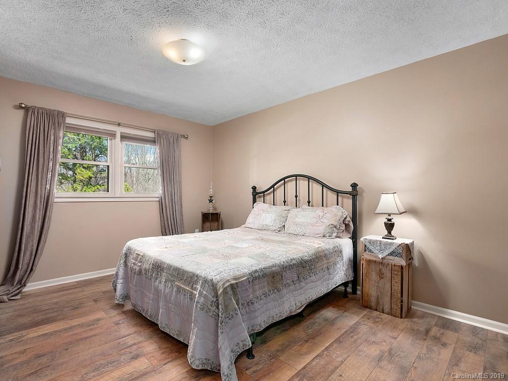 263 Stoney Brook Drive Clyde, NC 28721 - Photo 13 of 25 a bedroom with a bed and window