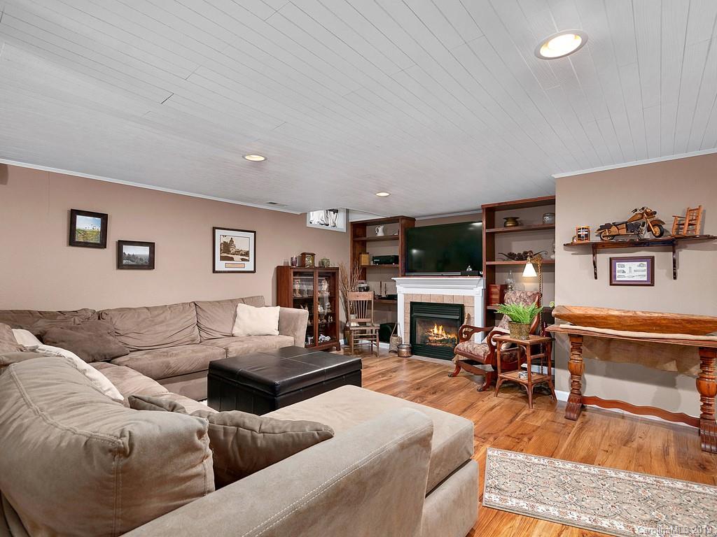 263 Stoney Brook Drive Clyde, NC 28721 - Photo 20 of 25 a living room with furniture and a fireplace