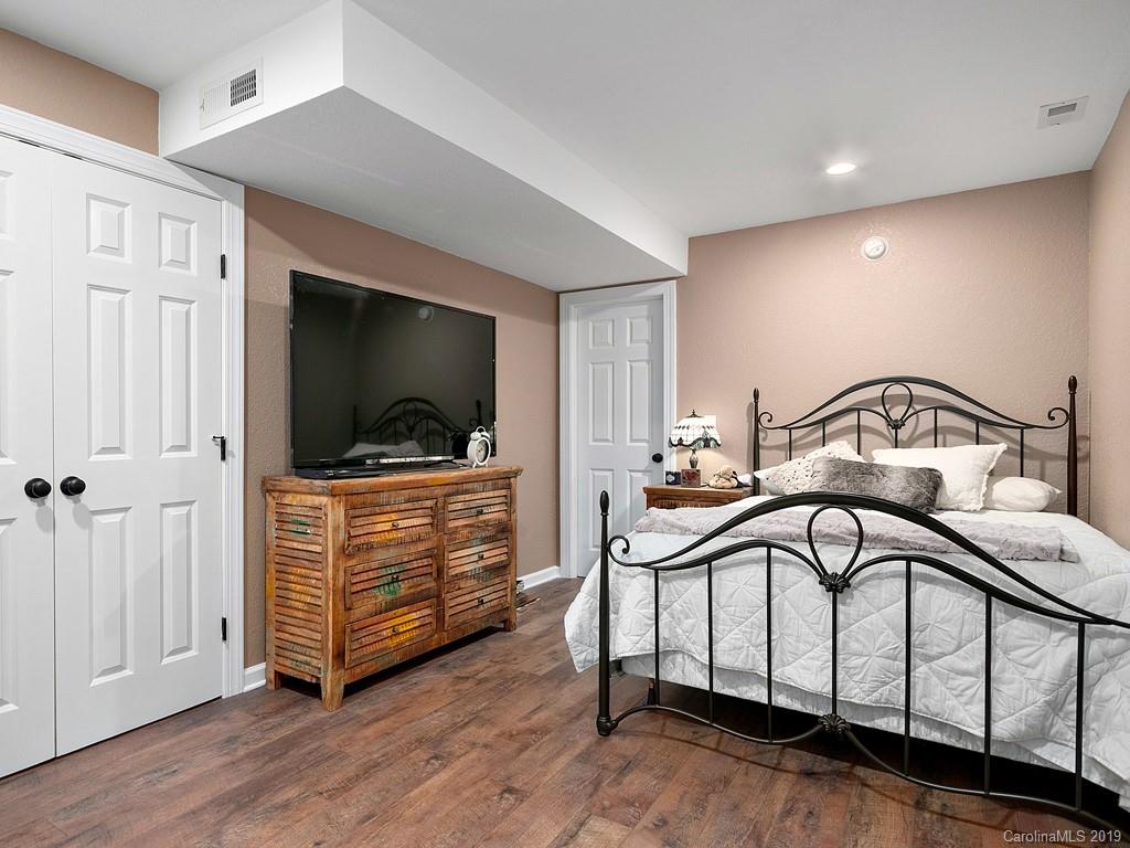263 Stoney Brook Drive Clyde, NC 28721 - Photo 22 of 25 a bedroom with a bed and a flat screen tv
