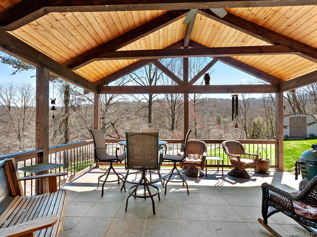 263 Stoney Brook Drive Clyde, NC 28721 - Photo 24 of 25 a view of a patio with a table and chairs under an umbrella
