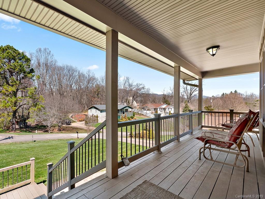 263 Stoney Brook Drive Clyde, NC 28721 - Photo 4 of 25 a view of a balcony with wooden floor and fence