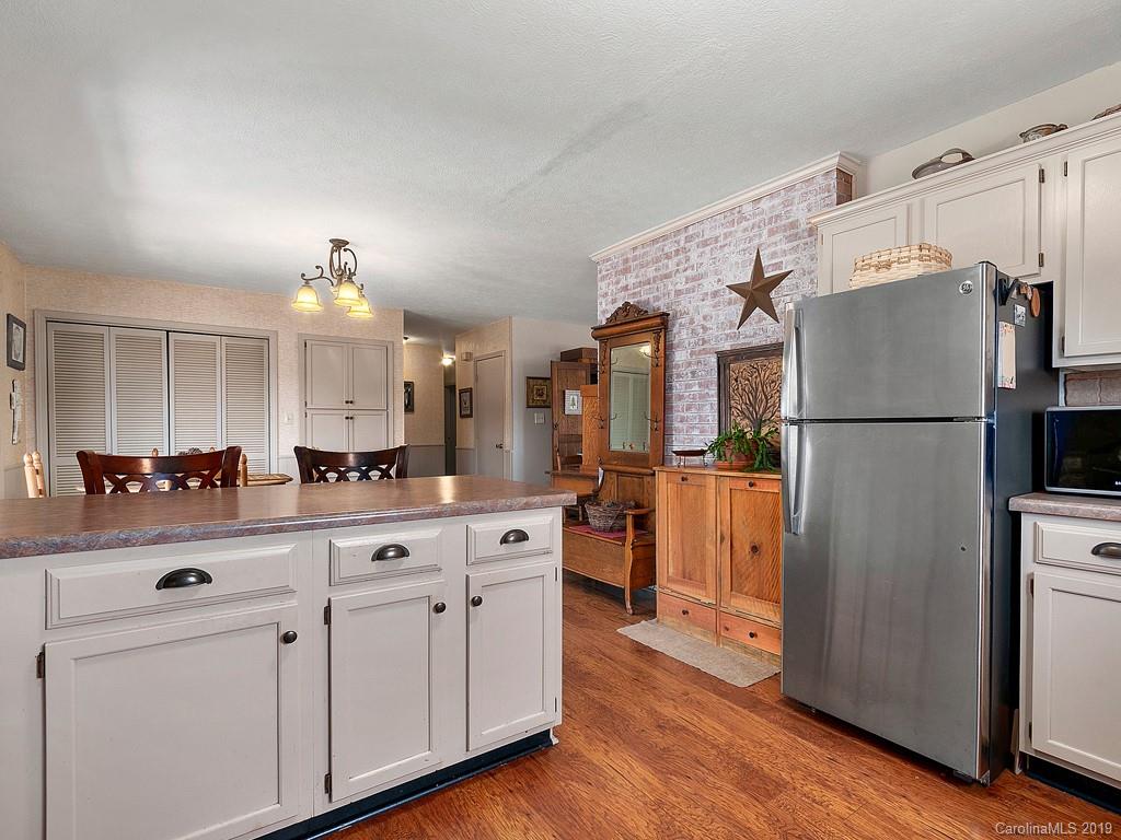 263 Stoney Brook Drive Clyde, NC 28721 - Photo 6 of 25 a kitchen with white cabinets and stainless steel appliances