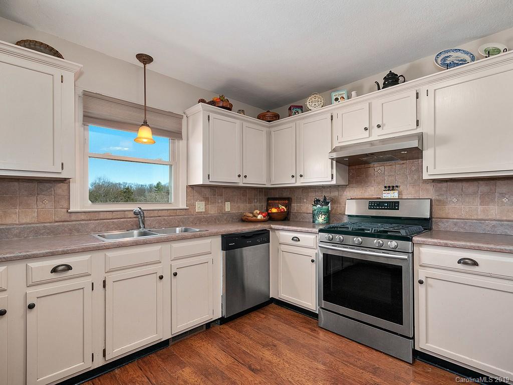 263 Stoney Brook Drive Clyde, NC 28721 - Photo 8 of 25 a kitchen with cabinets appliances a sink and a window