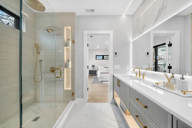 a spacious bathroom with a shower sink and mirror