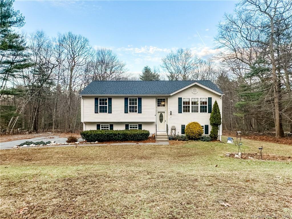 7 Pequot Circle Killingly, CT 06239 - Photo 1 of 1 a front view of a house with a yard covered with snow and trees