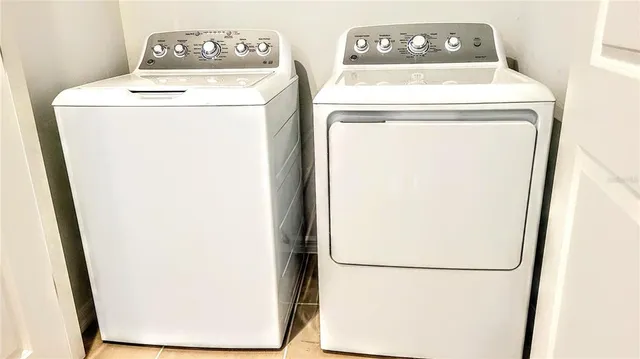 a view of a house in front of a yard with plants