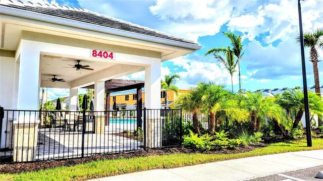 a view of a patio with table and chairs potted plants and floor to ceiling window