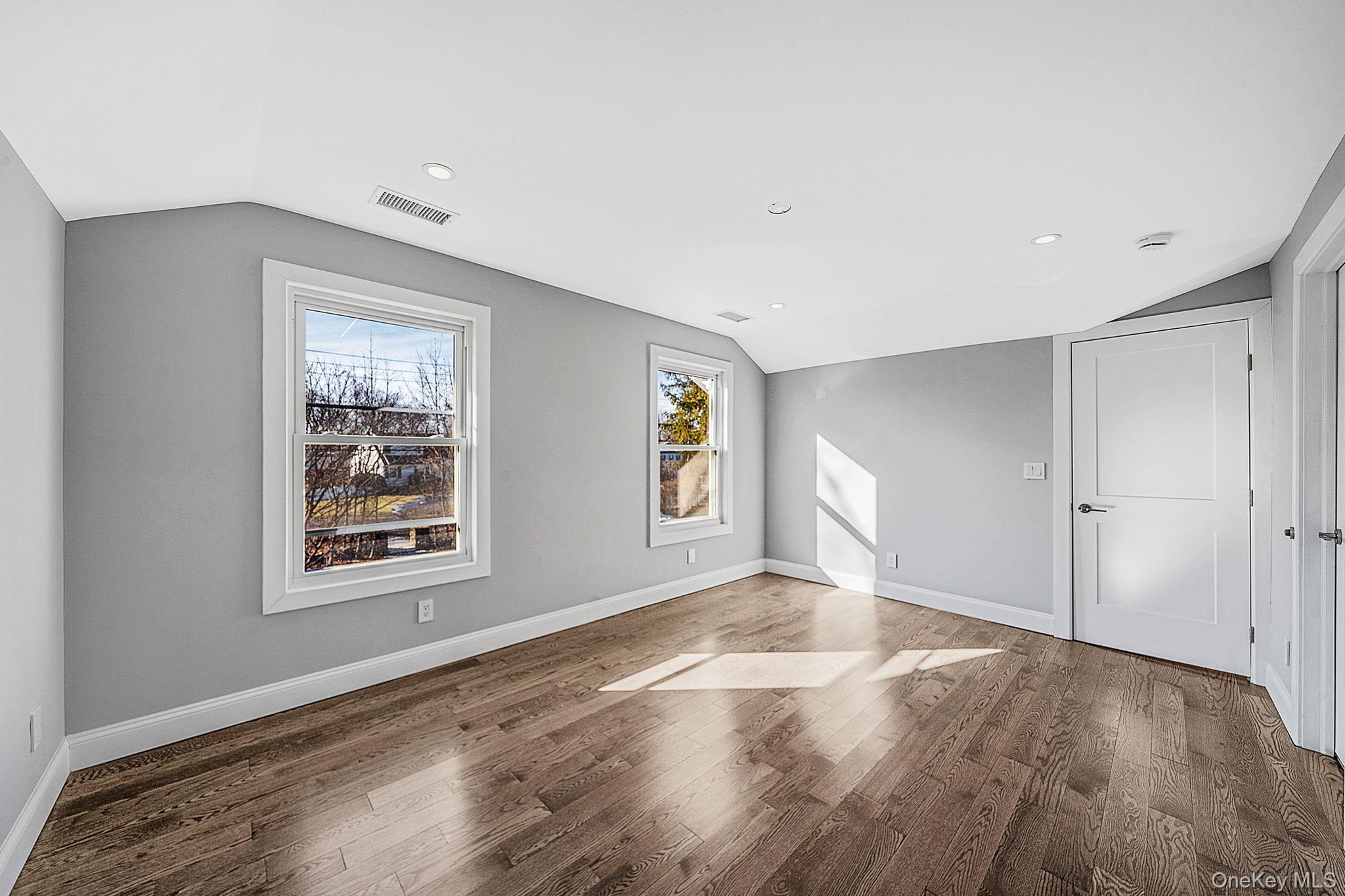141 Wilmot Road Scarsdale, NY 10583 - Photo 26 of 49 Spare room with lofted ceiling, wood finished floors, and recessed lighting