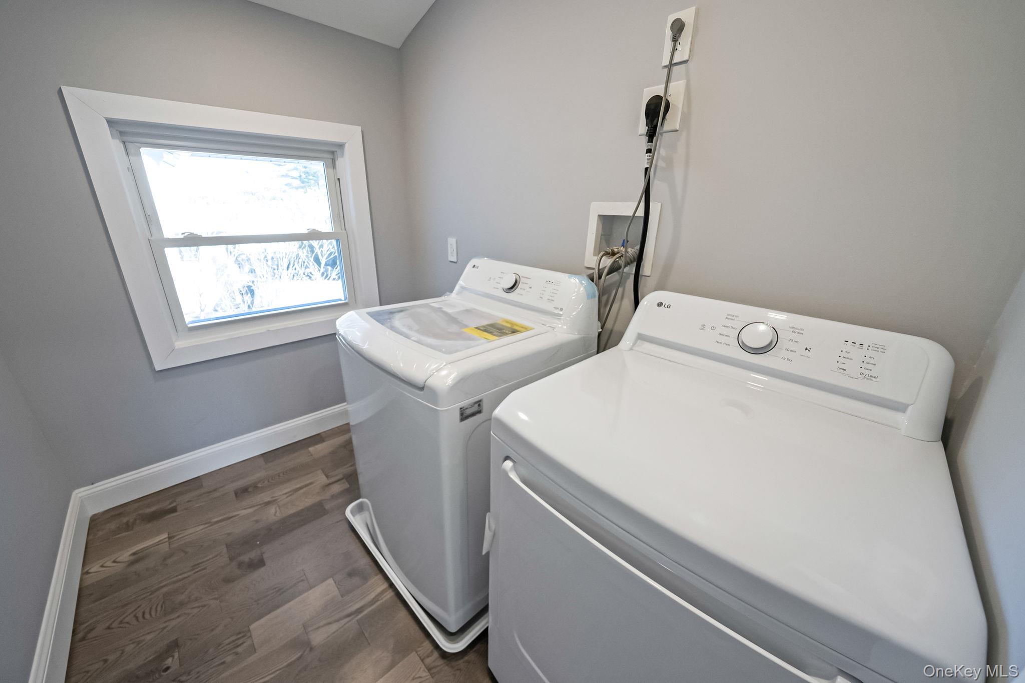 141 Wilmot Road Scarsdale, NY 10583 - Photo 27 of 49 Washroom featuring dark wood-style flooring and washer and dryer