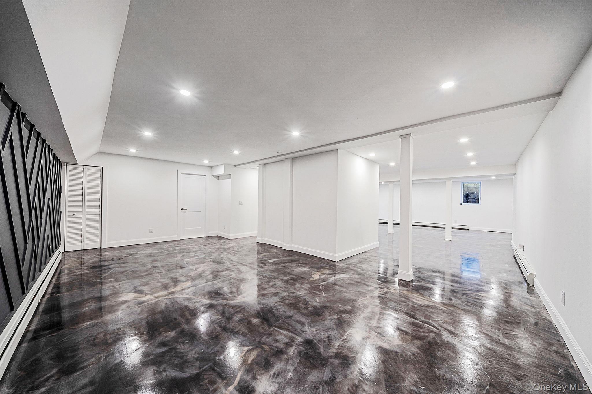 141 Wilmot Road Scarsdale, NY 10583 - Photo 36 of 49 Basement with baseboard heating, recessed lighting, and a baseboard radiator
