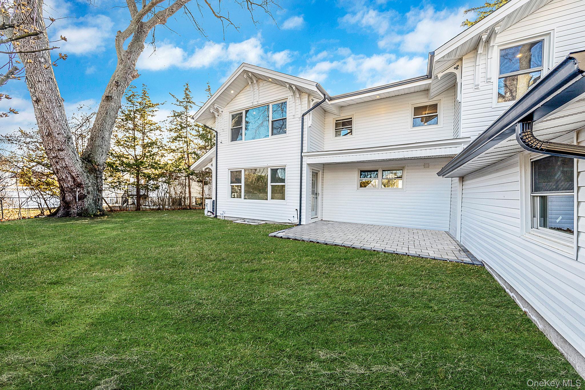 141 Wilmot Road Scarsdale, NY 10583 - Photo 43 of 49 Rear view of property with a patio area and a yard