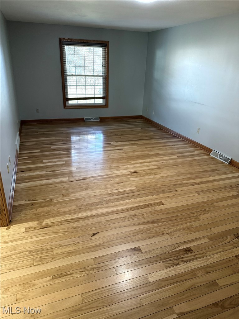 5115 Raspberry Lane Mineral Ridge, OH 44440 - Photo 12 of 25 Spare room with visible vents, baseboards, and light wood-style floors