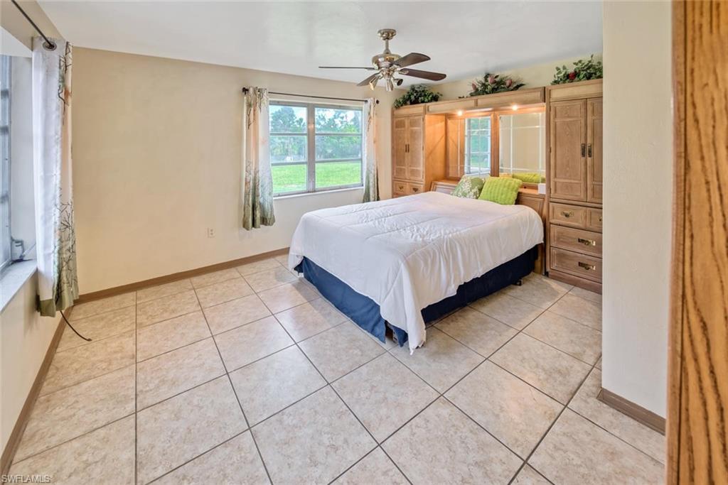 29 Caribbean Road Naples, FL 34108 - Photo 29 of 32 Tiled bedroom featuring ceiling fan