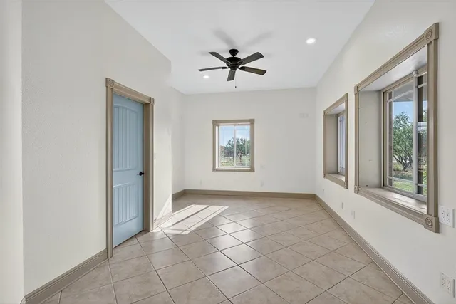 a view of a livingroom with a ceiling fan and window