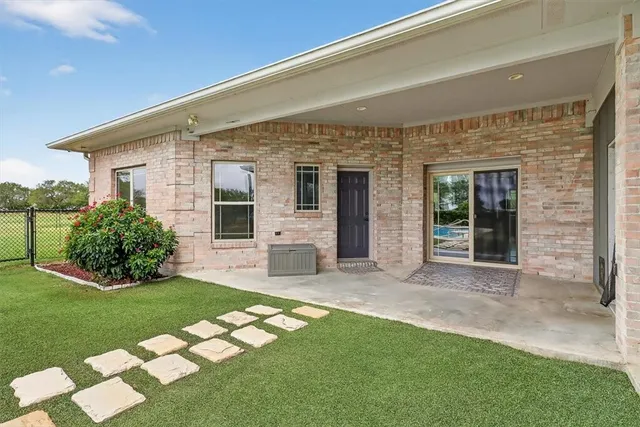 a view of a house with a yard and sitting area
