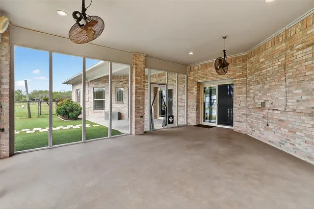 a view of an empty room with floor to ceiling window and stairs
