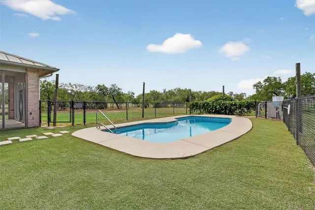 a view of a swimming pool with a yard