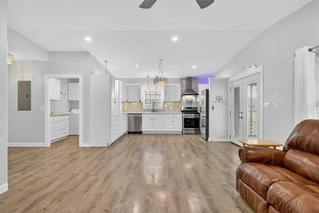 a living room with stainless steel appliances kitchen island granite countertop furniture and a kitchen view