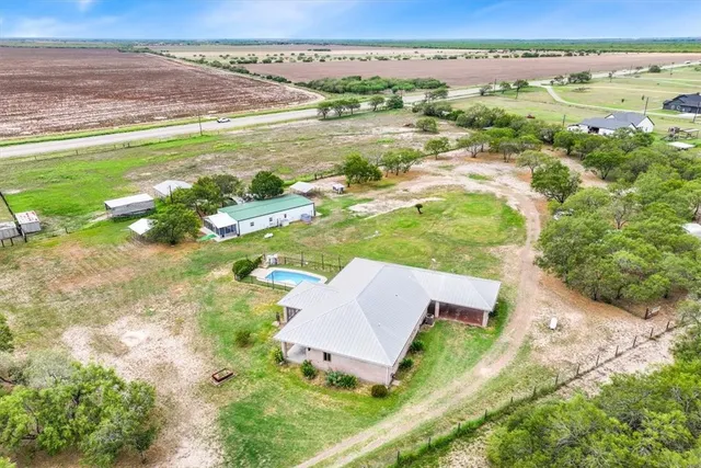 an aerial view of residential houses with outdoor space