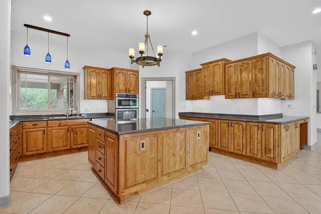 a kitchen with stainless steel appliances granite countertop a stove and a wooden cabinets