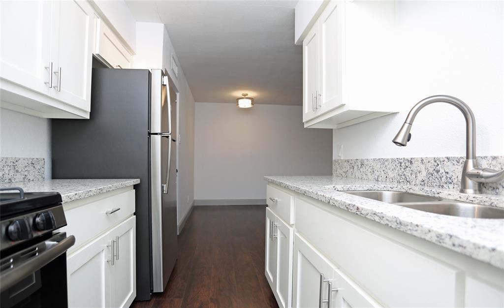 404 East 9th Street, Unit 4205 Dallas, TX 75203 - Photo 12 of 12 a kitchen with a sink and a refrigerator