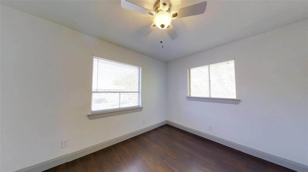 404 East 9th Street, Unit 4205 Dallas, TX 75203 - Photo 3 of 12 an empty room with a window and a fan