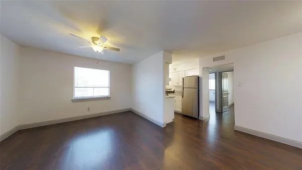 an empty room with wooden floor and a window