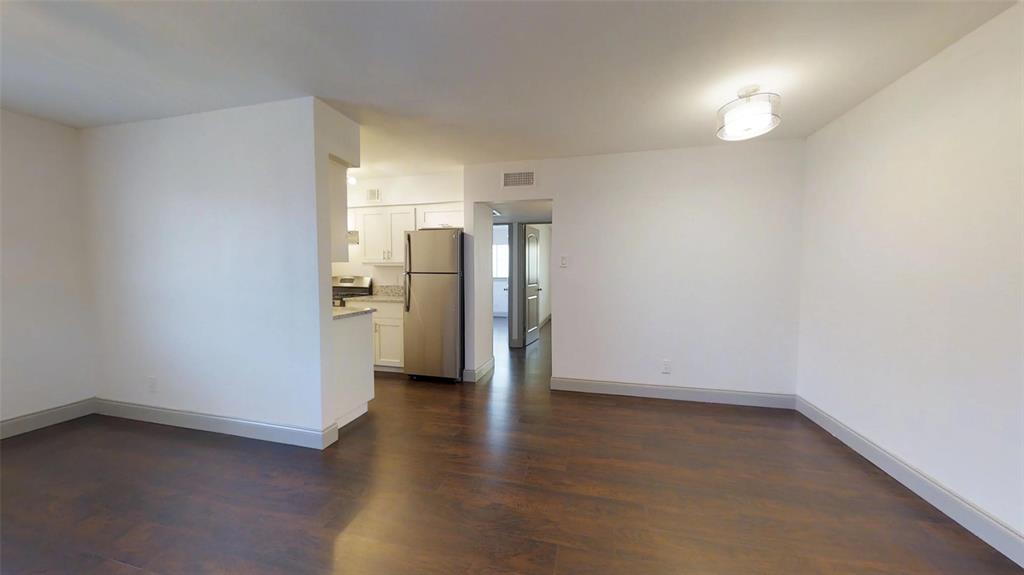 404 East 9th Street, Unit 4205 Dallas, TX 75203 - Photo 5 of 12 a view of a kitchen with a sink and refrigerator