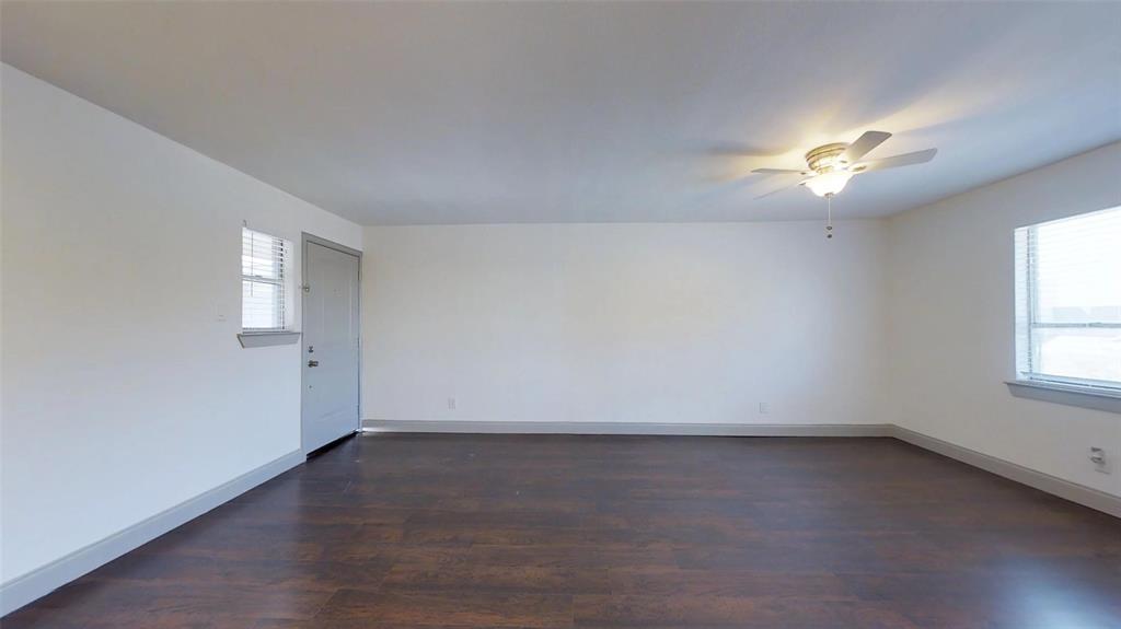 404 East 9th Street, Unit 4205 Dallas, TX 75203 - Photo 6 of 12 wooden floor in an empty room with a window