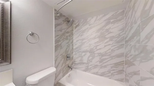 a bathroom with a toilet and a shower curtain