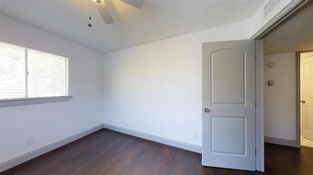 404 East 9th Street, Unit 4205 Dallas, TX 75203 - Photo 9 of 12 a view of an empty room with wooden floor and a window
