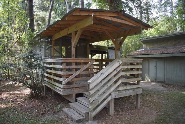 a view of a wooden deck with a small yard