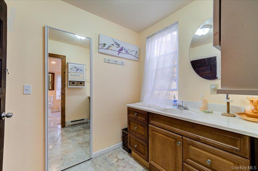 30 Walnut Mountain Road Liberty, NY 12754 - Photo 42 of 48 a bathroom with a sink a mirror and a vanity