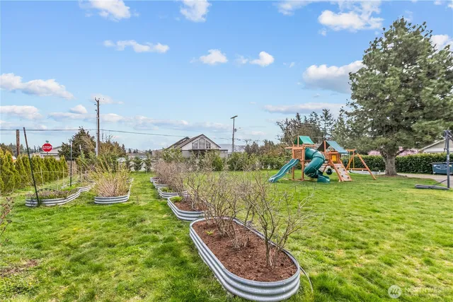 a view of a patio with table and chairs under an umbrella