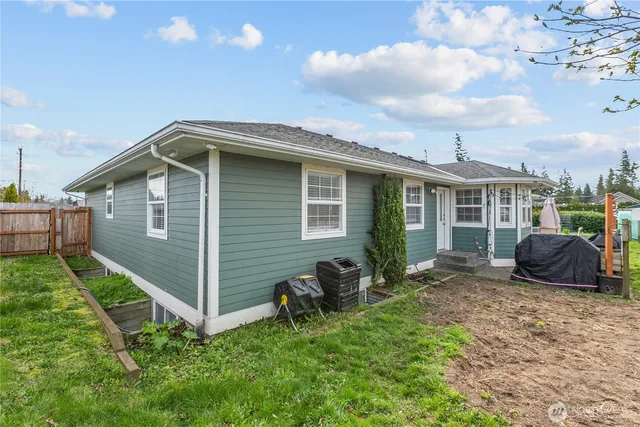 a backyard of a house with barbeque oven fire pit table and chairs