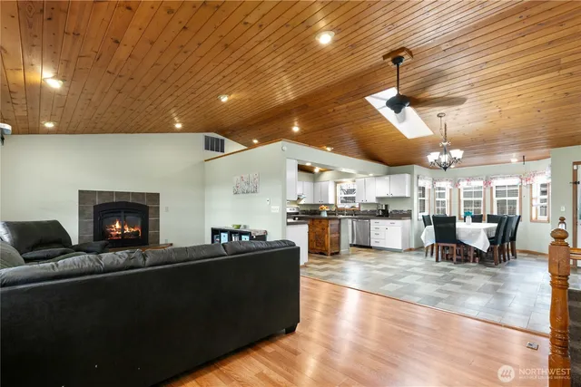 a living room with lots of furniture and kitchen view