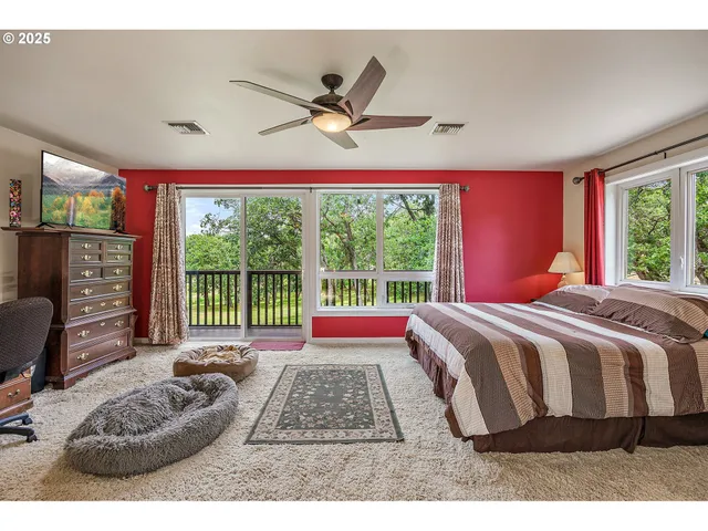 a bedroom with a bed and a large window