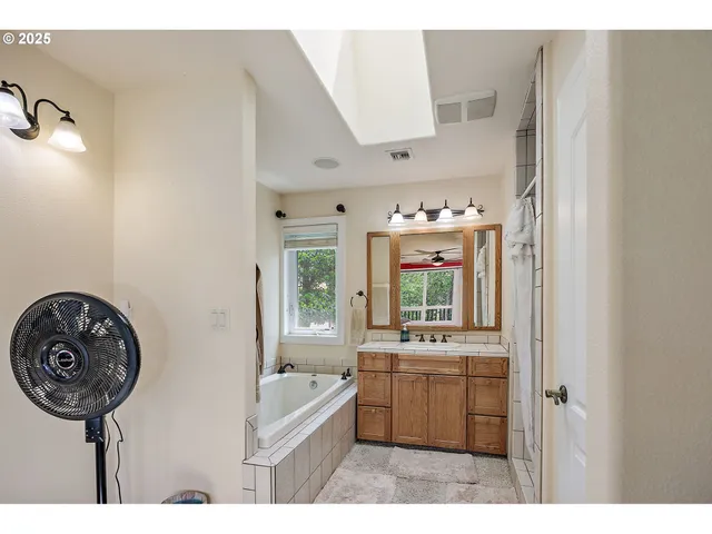 a bathroom with a sink a mirror and a bathtub