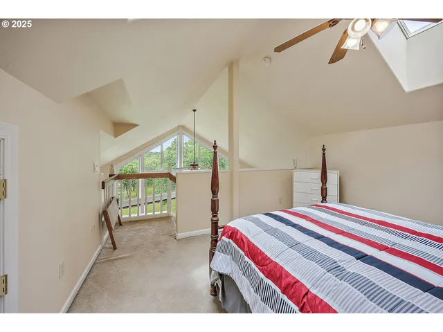 a living room with a bed furniture and a window