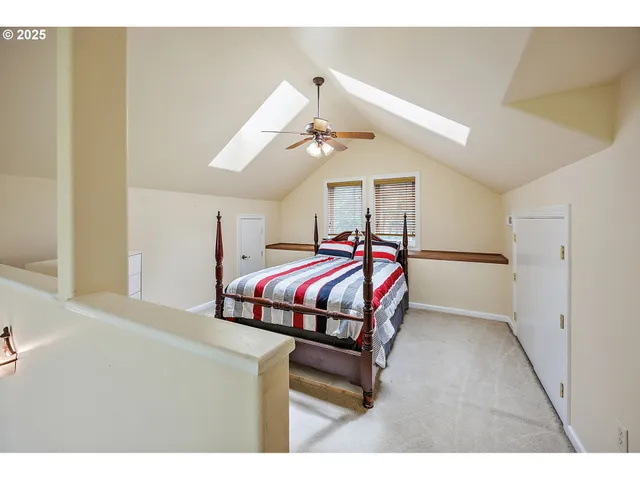 a bedroom with a bed a dresser and a window