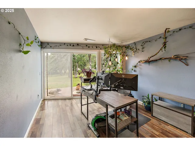 a living room with furniture and a floor to ceiling window