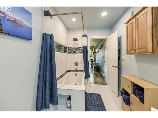 a bathroom with a glass shower door and a sink