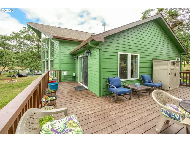 a balcony with wooden floor table and chairs