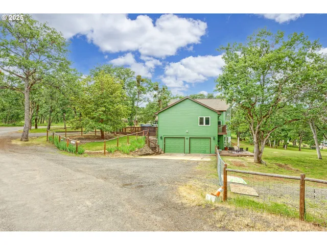 a backyard of a house with barbeque oven table and chairs