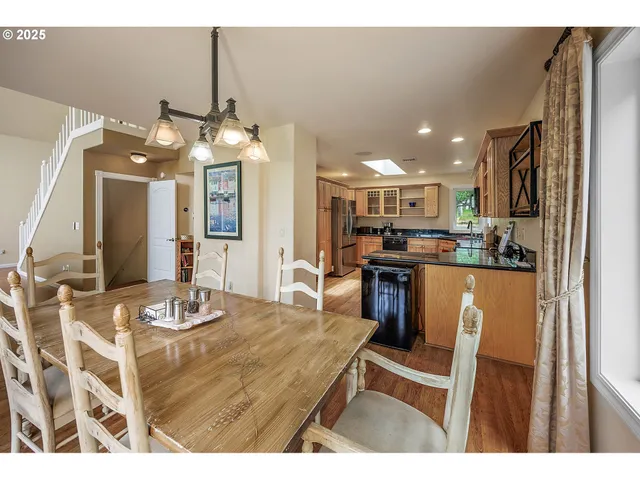 a kitchen with kitchen island granite countertop a sink cabinets and stainless steel appliances