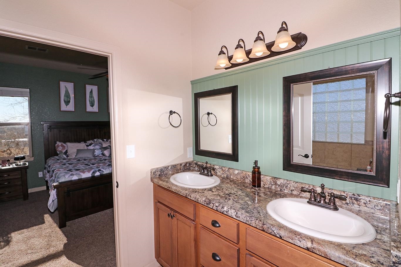 2011 Roma Avenue Fruita, CO 81521 - Photo 17 of 31 a bathroom with a granite countertop sink and a mirror
