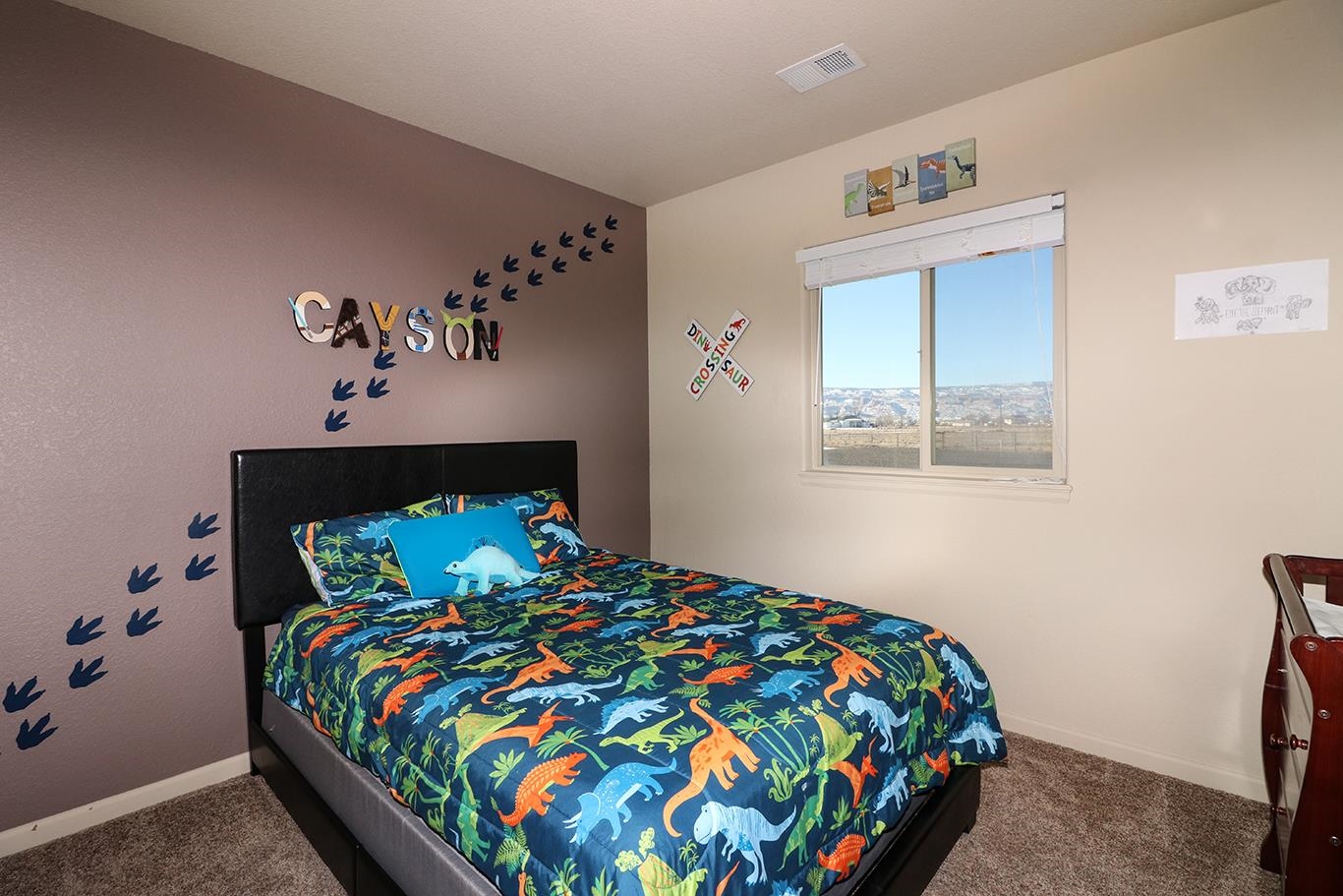 2011 Roma Avenue Fruita, CO 81521 - Photo 20 of 31 a bedroom with a bed and a painting on the wall