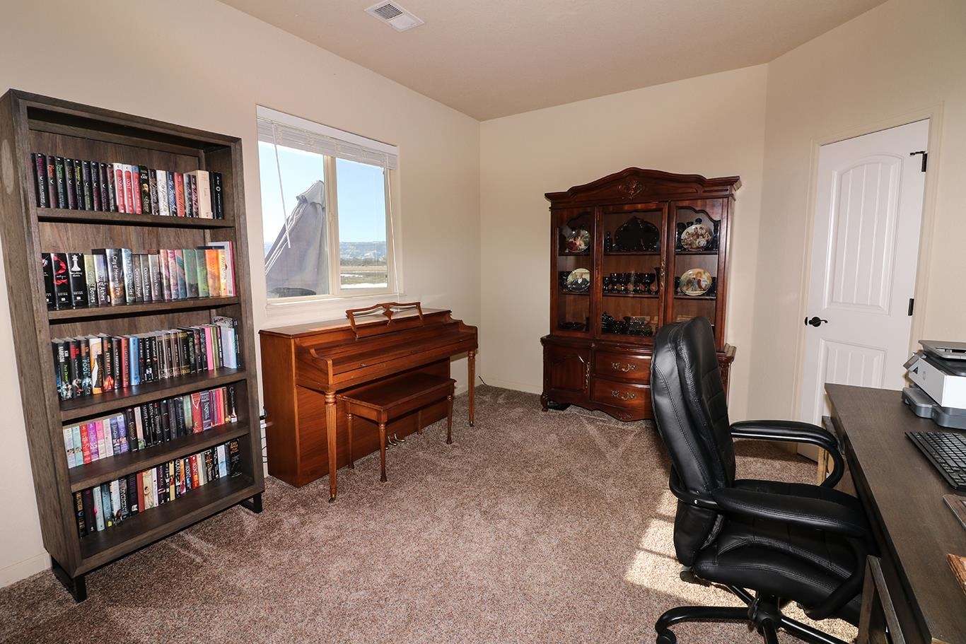 2011 Roma Avenue Fruita, CO 81521 - Photo 23 of 31 a view of a workspace with furniture and a bookshelf